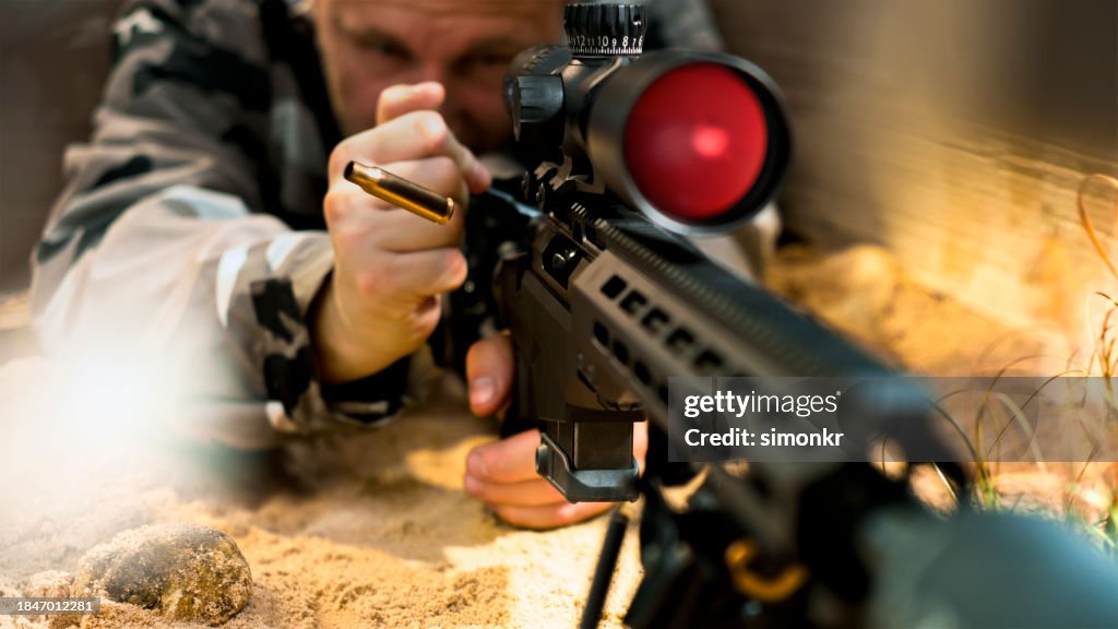 Soldier firing machine gun during battle