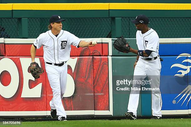 Andy Dirks and Austin Jackson of the Detroit Tigers react after Dirks caught a ball hit by David Ortiz of the Boston Red Sox in the fourth inning of...