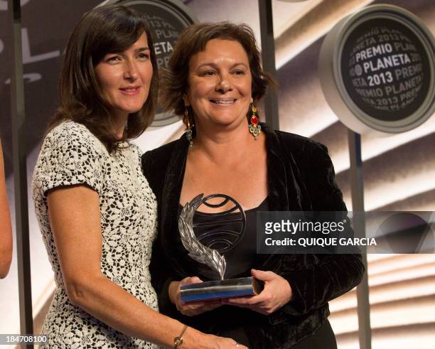 The winner of the 2014 Premio Planeta literature award, Spanish writer Clara Sanchez , poses with finalist Angeles Gonzalez-Sinde during the ceremony...