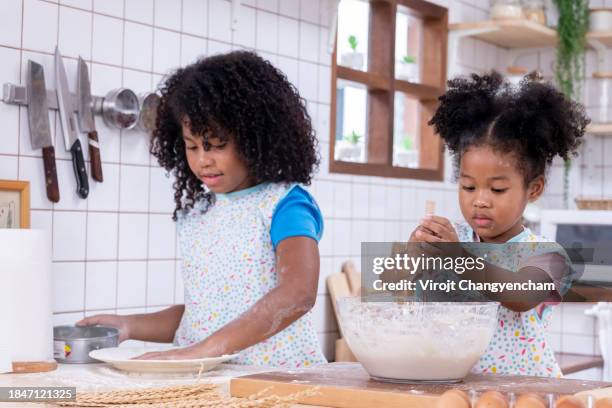 the two siblings are having fun playing in the kitchen - fat asian boy stock pictures, royalty-free photos & images