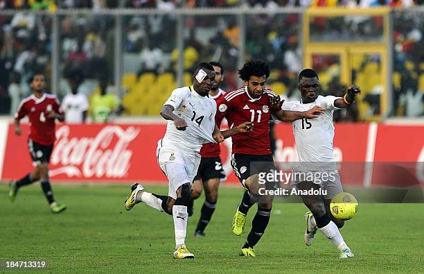Ghanaian Jerry Akaminko and Rashid Sumaila vie with Egyptian Mohamed Salah during the 2014 World Cup African qualifying first leg play-off match...