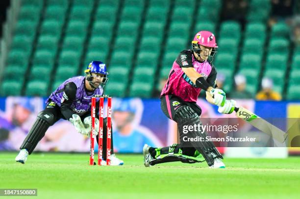 Daniels Hughes of the Sixers pulls a ball to the boundary during the BBL match between Hobart Hurricanes and Sydney Sixers at University of Tasmania...