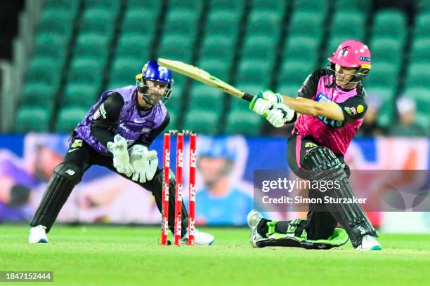 Daniels Hughes of the Sixers pulls a ball to the boundary during the BBL match between Hobart Hurricanes and Sydney Sixers at University of Tasmania...