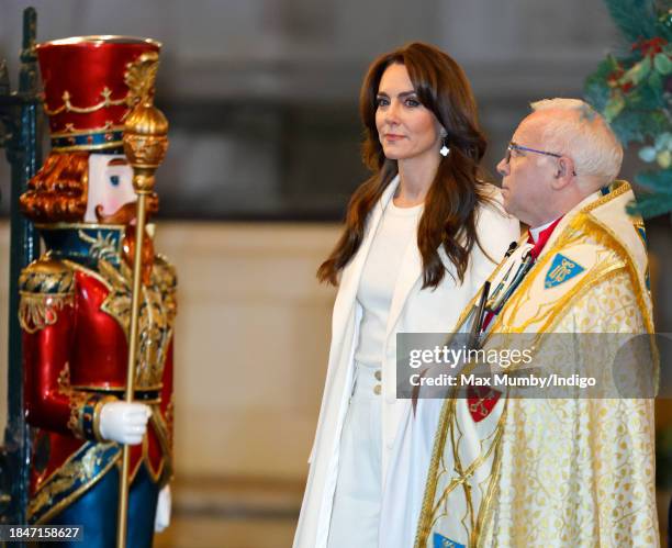 Catherine, Princess of Wales, accompanied by The Dean of Westminster The Very Reverend Dr David Hoyle, attends The 'Together At Christmas' Carol...