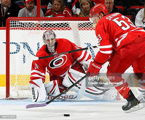 Jeff Skinner of the Carolina Hurricanes collects the puck ahead of goaltender Cam Ward during an NHL game against the Chicago Blackhawks at PNC Arena...