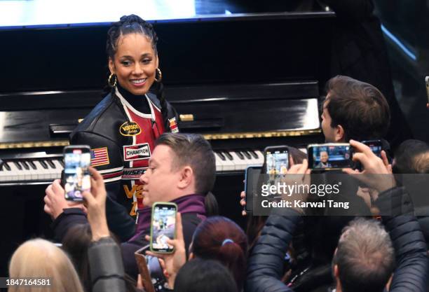 Alicia Keys performs on the Sir Elton John piano at St Pancras International Station on December 11, 2023 in London, England.