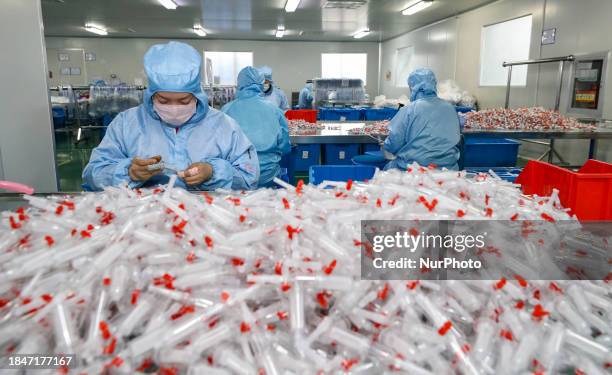 Workers are making medical infusion sets for export at a workshop in Huai'an City, Jiangsu Province, China, on December 14, 2023.