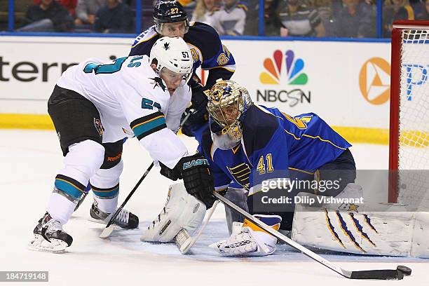 Tommy Wingels of the San Jose Sharks attempts to score a goal against Jaroslav Halak of the St. Louis Blues at the Scottrade Center on October 15,...