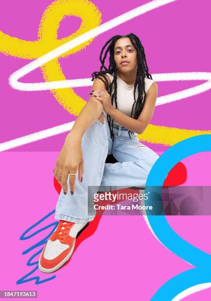 fashionable woman sitting against colourful background - multi coloured trousers stock pictures, royalty-free photos & images