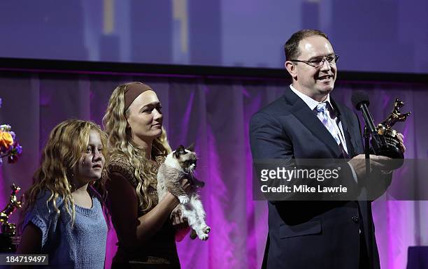 Bryan Bundesen accepts the Lifetime Achievement Award for Grumpy Cat, as Chrystal Bundesen and Tabatha Bundesen look on during The Friskies 2013 at...