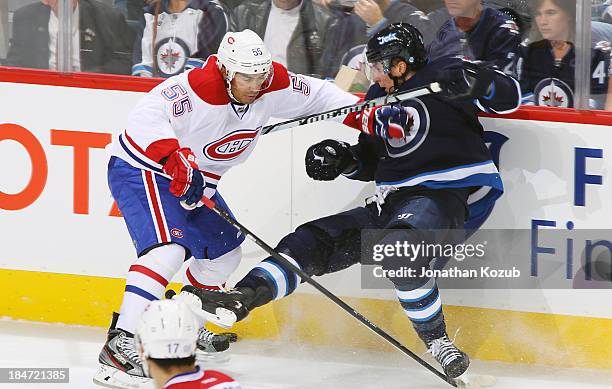 Francis Bouillon of the Montreal Canadiens checks Blake Wheeler of the Winnipeg Jets along the boards during second period action at the MTS Centre...