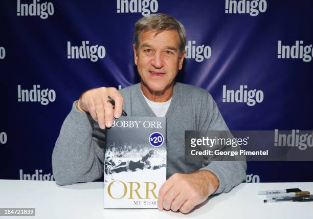 Hockey Great and Hall of Famer Bobby Orr signs copies of his new book "Orr, My Story" at Indigo Toronto Eaton Centre on October 15, 2013 in Toronto,...