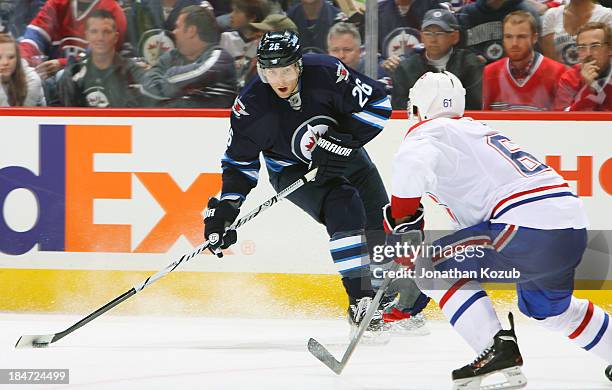 Blake Wheeler of the Winnipeg Jets plays the puck as Raphael Diaz of the Montreal Canadiens defends during third period action at the MTS Centre on...