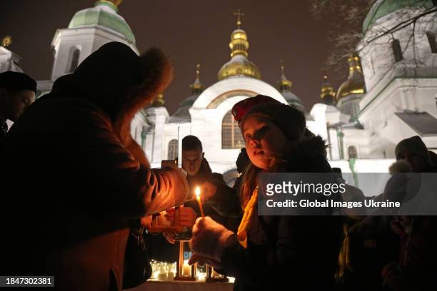 Plastuny share the flame of the Light of Peace to all those present at Saint Sophia Cathedral on December 10, 2023 in Kyiv, Ukraine. Ukrainian scouts...