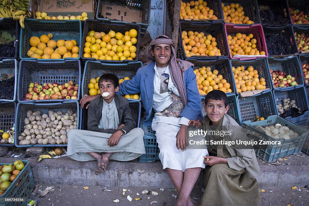 Three boys guarding a fruit shop