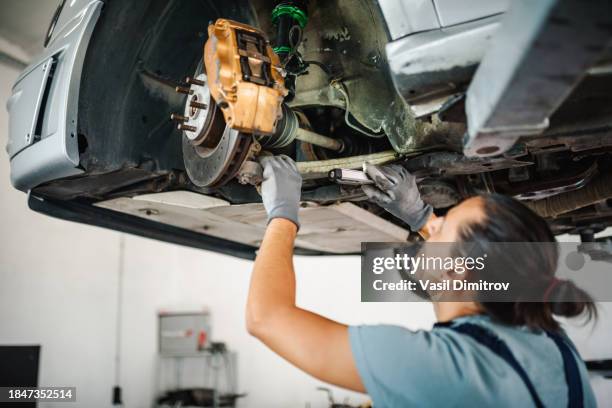 auto mechanic inspects car suspension. diagnostics of the condition of the car - brake stock pictures, royalty-free photos & images