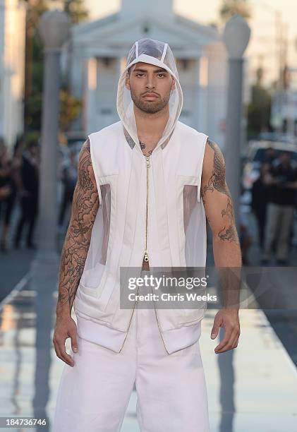 Model walks the runway at the Ashton Michael Spring 2014 Collection show on October 15, 2013 in Hollywood, California.