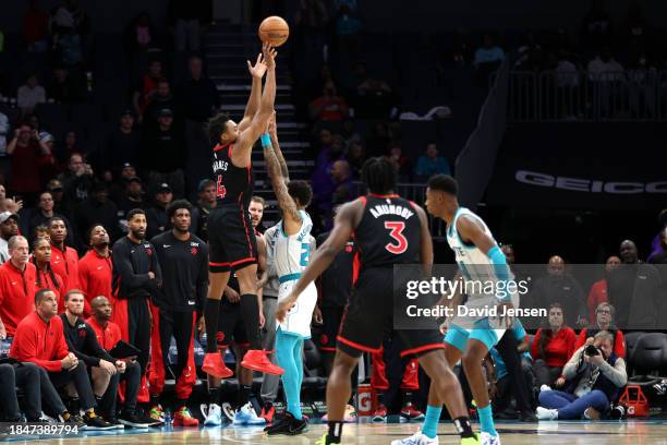 Washington of the Charlotte Hornets defends a shot by Scottie Barnes of the Toronto Raptors during the second half of an NBA game at Spectrum Center...