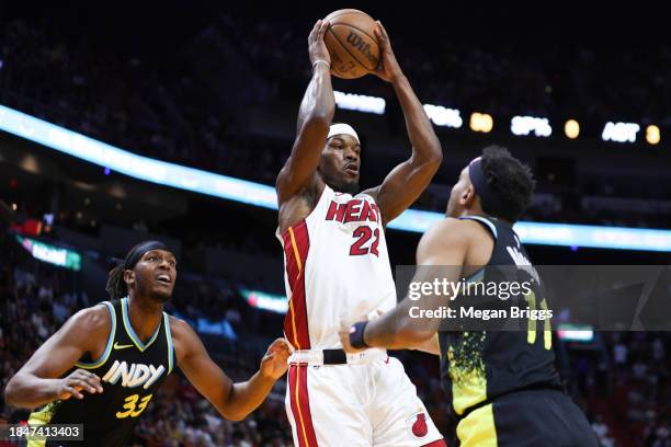 Jimmy Butler of the Miami Heat drives against Bruce Brown of the Indiana Pacers during the first quarter at Kaseya Center on December 02, 2023 in...