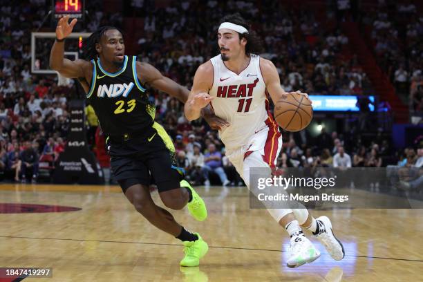 Jimmy Butler of the Miami Heat drives to the basket against Aaron Nesmith of the Indiana Pacers during the second quarter at Kaseya Center on...