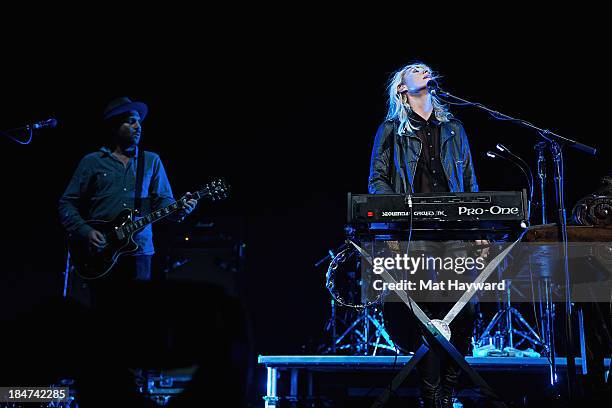 James Shaw and Emily Haines of Metric performs on stage at Key Arena on October 15, 2013 in Seattle, Washington.