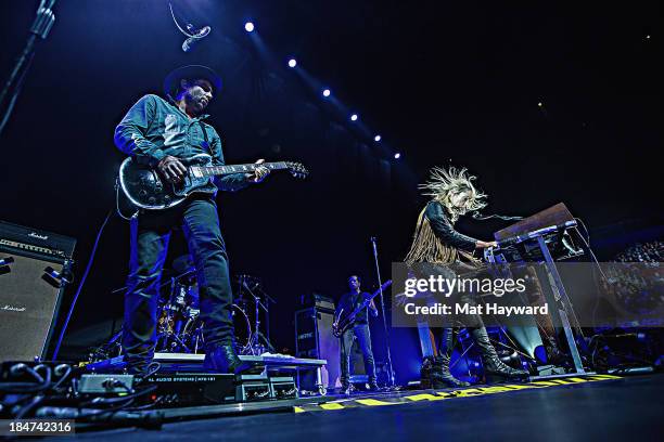 James Shaw and Emily Haines of Metric perform on stage at Key Arena on October 15, 2013 in Seattle, Washington.