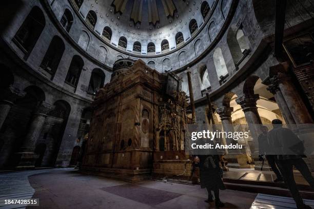 People visit the Church of the Holy Sepulchre as all Christmas celebrations were canceled due to Israeli-Palestinian conflict in Old City of...