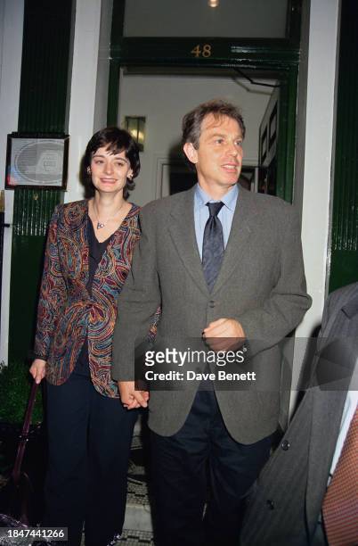 Prime Minister of the United Kingdom Tony Blair and English barrister Cherie Blair leaving the L'Escargot restaurant in London, October 1997.