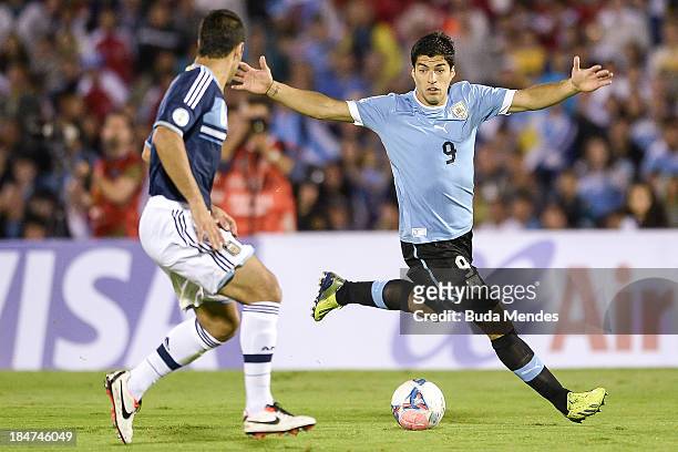 Luis Suarez of Uruguay vies for the ball with Sebastian Dominguez of Argentina during a match between Uruguay and Argentina as part of the 18th round...