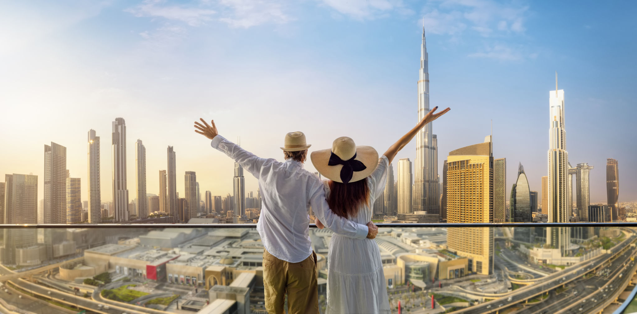 A tourist couple on vacation time enjoys the panoramic view of the Dubai skyline A tourist couple on vacation time enjoys the panoramic view of the Dubai skyline