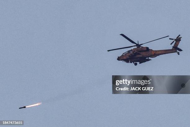 An Israeli air force attack helicopter fires a missile while flying in an area along the border with the Gaza Strip and southern Israel on December...