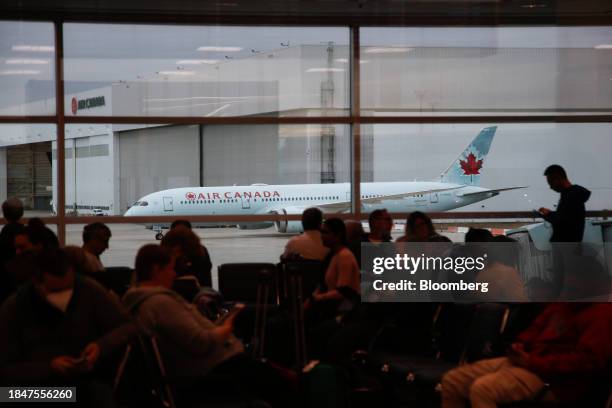 An Air Canada plane outside of a waiting area in Terminal 3 at Toronto Pearson International Airport in Toronto, Ontario, Canada, on Saturday, Dec....