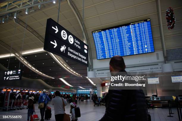 Passengers at Toronto Pearson International Airport in Toronto, Ontario, Canada, on Saturday, Dec. 9, 2023. The Greater Toronto Airports Authority...