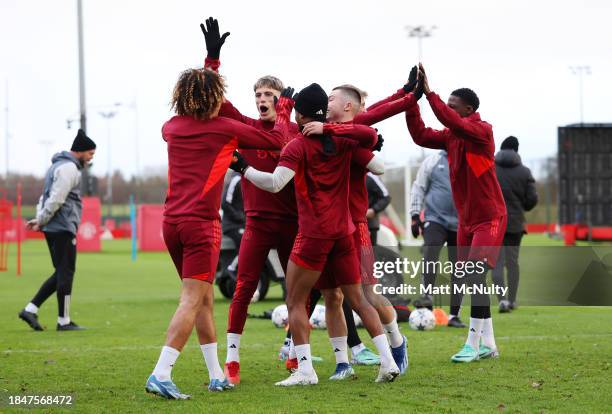 Alejandro Garnacho, Rasmus Hojlund and Kobbie Mainoo of Manchester United react during a training session at Carrington Training Ground on December...