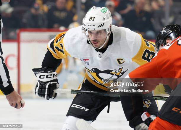 Sidney Crosby of the Pittsburgh Penguins prepares for a faceoff with Sean Couturier of the Philadelphia Flyers at the Wells Fargo Center on December...