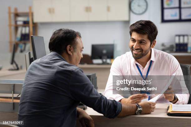 customer with bank manager in office stock photo - india people stock pictures, royalty-free photos & images