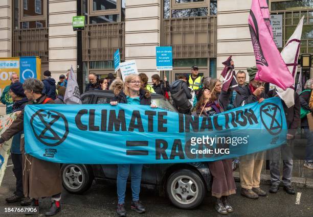 London, UK, 9 Dec 2023, Activists from the Climate Justice Coalition protest outside BP's London HQ at the "#NowWeRise â A Day of Action for Climate...