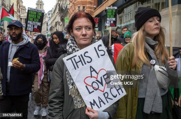 London, UK, Dec 9 2023, A women carries a poster saying "This is a Love March" at a pro-Palestinian demonstration calling for an end to Israeli...