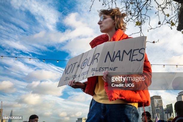 London, UK, Dec 9 2023, A lone Jewish woman holds a placard saying "Not in our names, Jew for a free Palestine" at a pro-Palestinian demonstration...