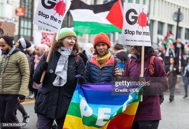 London, UK, Dec 9 2023, Three women hold a rainbow banner saying "Peace" and placards at a demonstration calling for an end to Israeli attacks on...