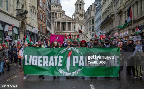 London, UK, Dec 9 2023, Celtic football fans hold a banner reading "Liberate Palestine" outside St Pauls Cathedral at a demonstration calling for an...