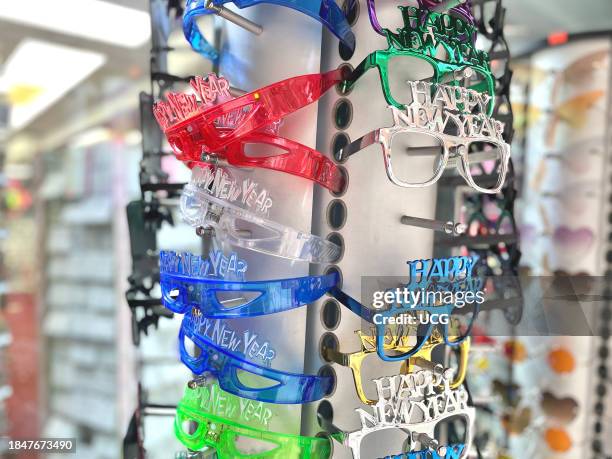 New Year's Eve costume eyeglasses for sale at a souvenir shop in Times Square for people celebrating the new year in New York City.