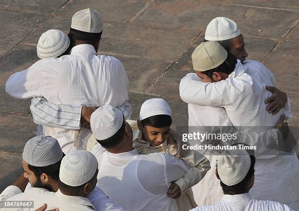 Poeple wishing each other 'Eid Mubarak' after the namaz on the occasion of Eid al-Adha at Jama Masjid on October 16, 2013 in New Delhi, India....