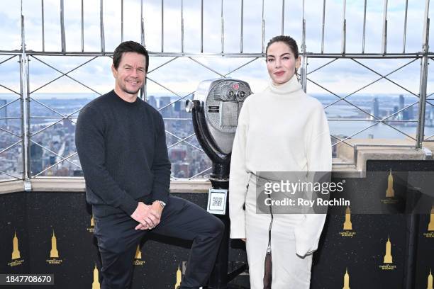 Mark Wahlberg and Michelle Monaghan pose as the cast of Apple TV's “The Family Plan” visits the Empire State Building at The Empire State Building on...