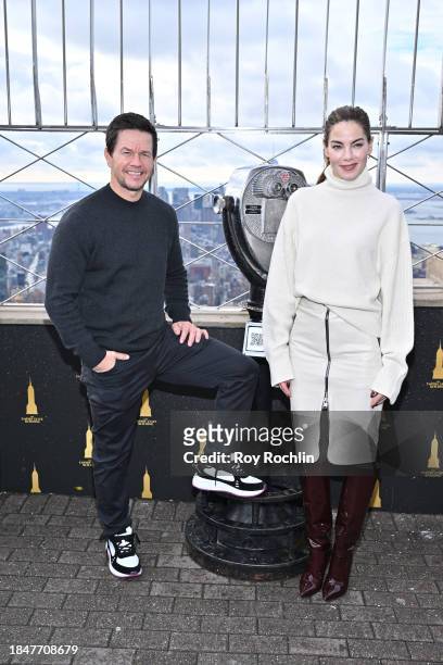 Mark Wahlberg and Michelle Monaghan pose as the cast of Apple TV's “The Family Plan” visits the Empire State Building at The Empire State Building on...