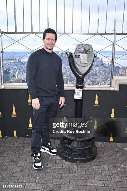 Mark Wahlberg poses as the cast of Apple TV's “The Family Plan” visits the Empire State Building at The Empire State Building on December 11, 2023 in...