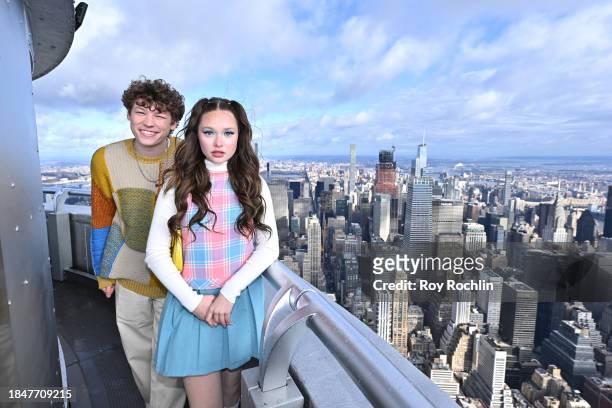 Van Crosby and Zoe Colletti pose as the cast of Apple TV's “The Family Plan” visits the Empire State Building at The Empire State Building on...