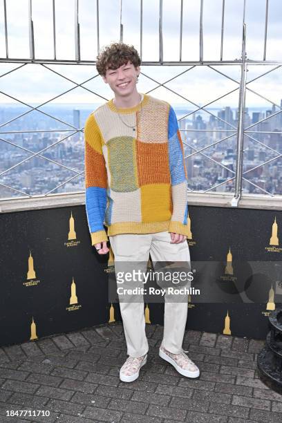 Van Crosby poses as the cast of Apple TV's “The Family Plan” visits the Empire State Building at The Empire State Building on December 11, 2023 in...