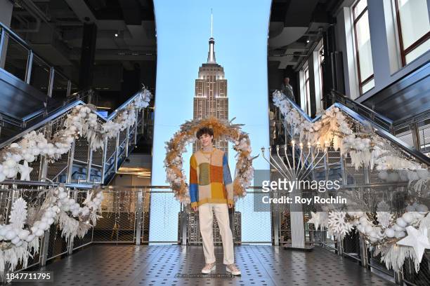 Van Crosby poses as the cast of Apple TV's “The Family Plan” visits the Empire State Building at The Empire State Building on December 11, 2023 in...