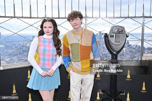 Zoe Colletti and Van Crosby pose as the cast of Apple TV's “The Family Plan” visits the Empire State Building at The Empire State Building on...